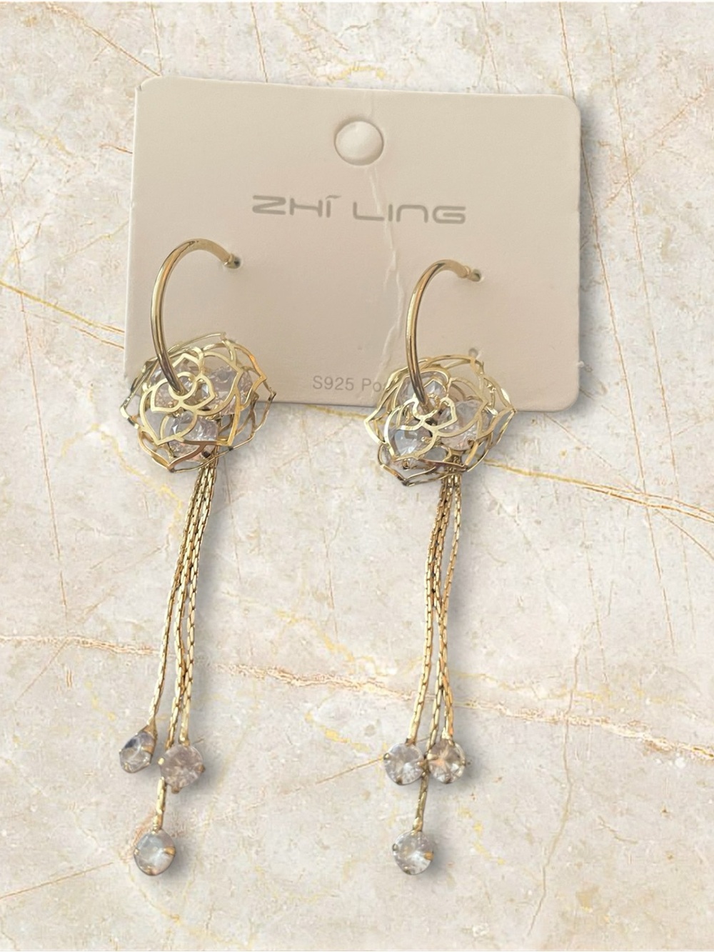 Fashion gold tone pierced earrings with clear crystals.